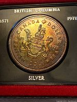 Close-up photo of the silver coin showing the detailed design of the Canadian coat of arms and inscriptions.