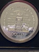 Reverse of the 1977 Canadian Silver Dollar featuring throne design and inscriptions including CANADA and DOLLAR.