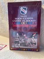 Front view of the unopened 1990-91 WHL hockey cards box with logo, title, and player action photo.