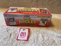 View of the sealed 1990 Score NHL Hockey Premier Edition box, red with NHL player images and bilingual card details.