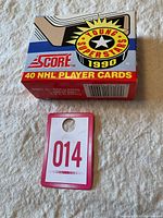 Factory sealed cardboard box of 1990 Score NHL Young Superstars hockey player cards with colorful graphics and product labeling.