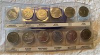 Photo shows two rows of 12 Canadian quarters, each quarter representing a month and province or territory, in a plastic case.