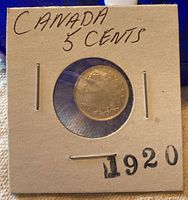 Photo of the coin in a card holder clearly labeled 'Canada 5 Cents 1920'