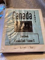 Front cover of the white stockbook folder labeled 'Canada Stamps Stockbook Canada Used - Volume II' with a large image of a Canadian stamp on it.