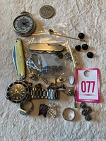 Full lot showing watches, rings, cufflinks, knife, pins, chain, and other small items