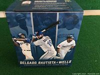 Box showing the commemorative trio bobblehead with images of Delgado, Bautista, and Wells and text marking 40th season.