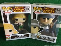 Penny and Inspector Gadget Funko Pop figures in original boxes, showing front and side of boxes and figures.