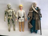 Front view of all three figures for identification and condition showing Luke Skywalker, C-3PO and Mas Amedda figures.