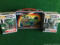 Metal GI Joe lunch box with two boxed Funko Pop figures on either side