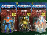 Three packaged Masters of the Universe figures: Faker, Buzz-Off, and Sorceress shown from the front.