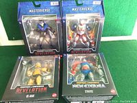 Four boxed Masters of the Universe action figures, clearly showing packaging and branding, all in original box packaging.