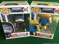 Two Masters of the Universe Funko Pop figures in original boxes: Dragstor #85 and Sy-Klone #995 side by side.