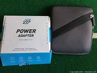 Closed white and blue retail box labeled 'Power Adapter Portable Mobile Devices'.