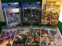 Photo showing all three boxed Masters of the Universe Revelation figures, the cereal box with unopened toy, and four comic books laid out, clearly visible for evaluation.