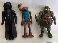 Three Star Wars action figures: Darth Vader, Hammerhead, and Gamorrean Guard side by side on a plain background.
