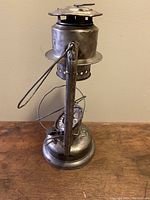 Full view of antique GSW Beacon lantern showing metal body, burner, handle, missing chimney glass