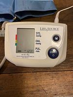 Close-up of the Life Source digital blood pressure monitor control panel with buttons and display.