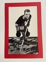 Front side of Bee Hive Group I hockey photo showing Jimmy Ward in uniform with hockey stick and autograph.