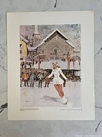 Front colored print depicting Barbara Ann Scott figure skating in front of a snowy village scene with crowd and church building.