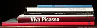Side view of six art books stacked, titles include Miro, Otto Mancioli, Carl Milles, Viva Picasso