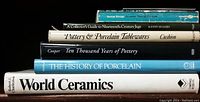 Stacked view of six books related to ceramics, pottery, and porcelain including titles by Cooper, Charleston, Cushion, and others.
