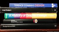 Five books stacked showing spines with titles focused on design and graphic design topics. Colors include blue, black, yellow, and green.