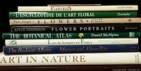 Books stacked showing spines with titles about flowers and botanical art.