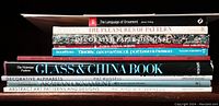 Stack of nine books with titles visible showing subjects on pattern, ornament, alphabets, and decorative designs.