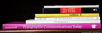 Five typography books stacked sideways highlighting their titles on the spines in a group shot.
