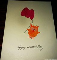 Single Mother's Day card featuring a stylized orange owl holding two red heart balloons with 'happy mother's day' message.
