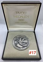 Medallion presented in original box with interior lid showing Tivoli Medallion branding, year 1980 and designer Harry Elstrom