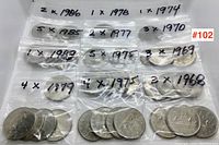 Photo showing multiple plastic bags with Canadian dollar coins each labeled with year and quantity.