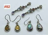 Photo showing three pairs of vintage sterling silver earrings: 1 pair stud multistone drop, 1 pair amber teardrop dangle, 1 pair abalone teardrop dangle