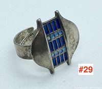 Front three-quarter view showing ring design, shape, and enamel detail.