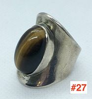 Angled front view showing oval tiger eye cabochon on sterling silver band