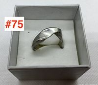 Front view of the men's sterling silver twisted ring in a white box showing overall shape and design.