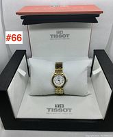 Watch displayed on pillow inside open Tissot box