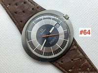 Top-down view of watch face showing dial, hands, date at 3 o’clock and part of strap