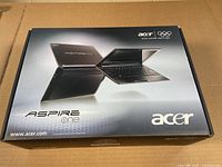 Original packaging box for Acer Aspire One laptop showing branding and images of the laptop, indicating model and official product box.