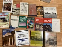 Two images showing a total of 27 art and architecture books, many about Frank Lloyd Wright and home improvement topics.