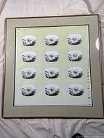 Full view of framed sheet of 12 stamps, showing overall presentation and mounting.