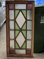 Single view of one stained glass window showing design and frame