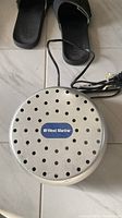 Top view of round metal dehumidifier showing ventilation holes and West Marine logo.