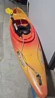 Full view of kayak with two-piece paddle and seat installed