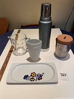 Image showing all five lot items together: Stanley thermos, glass measuring cup, porcelain vase, porcelain tray, and thermo pot