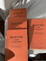 Five volumes of advance reading copies of "Boston" by Upton Sinclair, showing front cover titles and some spine details.