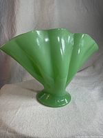 Front and side view of green jadeite glass fan vase showing ruffled edge and fan design.