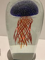 Front view of extra-large glass paperweight featuring detailed jellyfish inside.