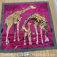 Full view of scarf flat showing entire giraffe family print and gray border