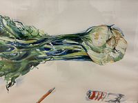 Close-up of painted bulb, green stalk, pencil and paint tube on paper